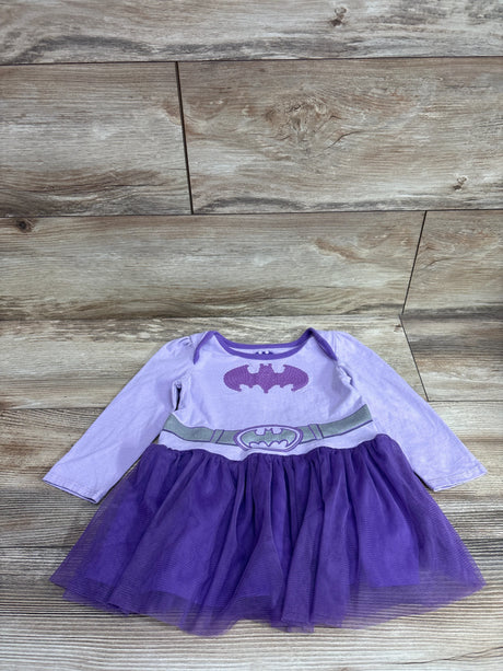 Front view of a purple DC Batman long sleeve tulle dress showcasing a Batman emblem and tulle skirt on wood flooring