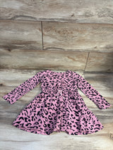 Front view of a pink leopard-print long-sleeve dress showcasing a gathered waist and flared skirt on a wood floor