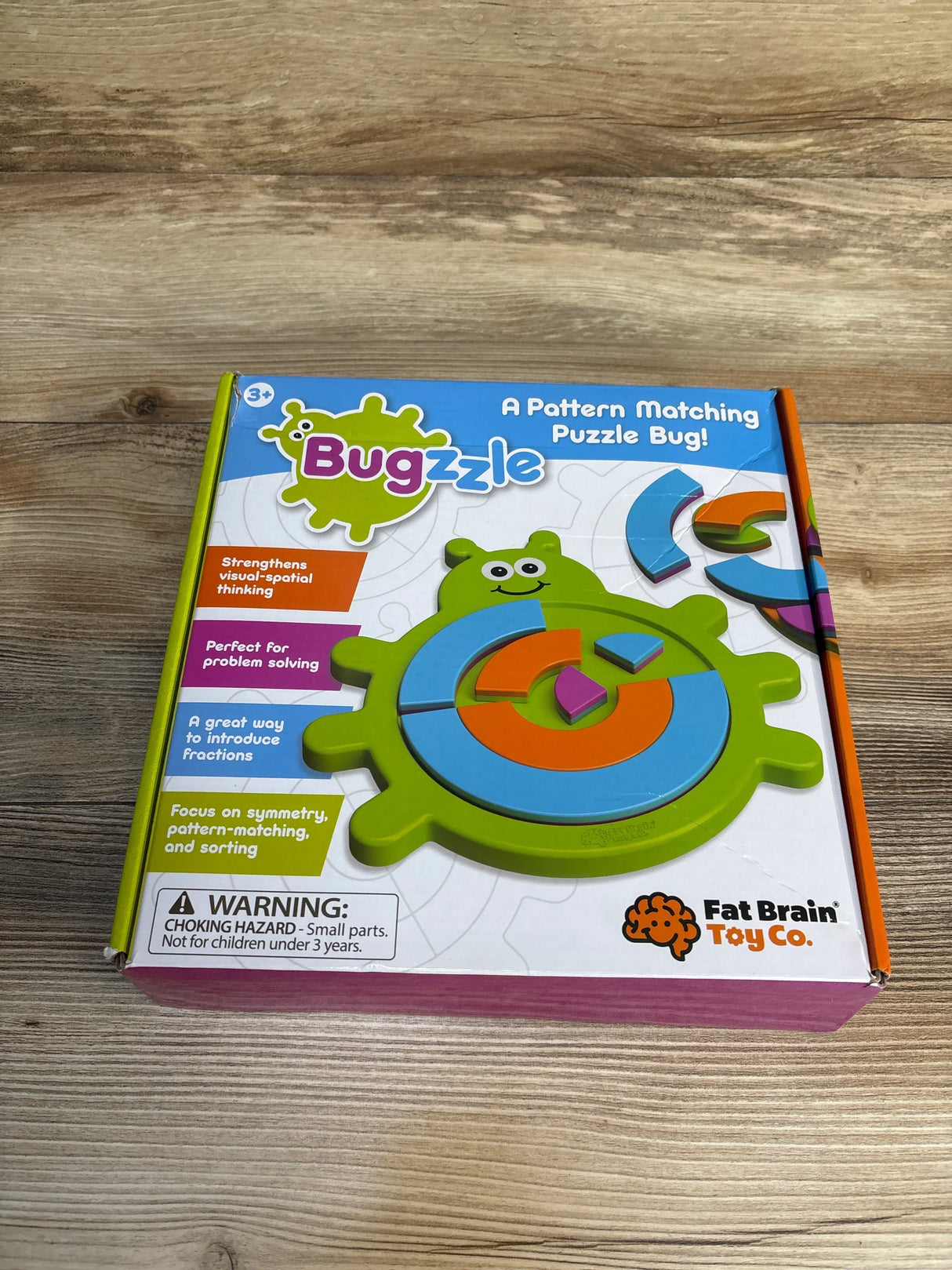 Buggzle pattern matching puzzle bug toy box on wood surface, educational toy for kids ages 3+