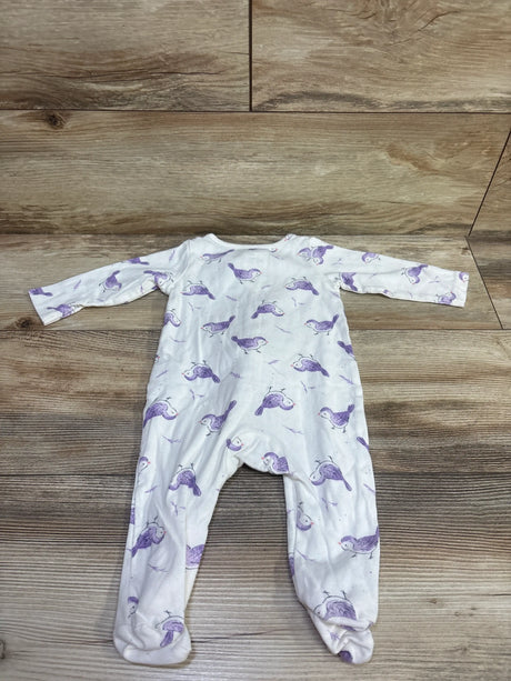 Top view of Just One You white 6m sleeper showcasing purple bird pattern, long sleeves, and footed design on wood flooring