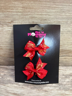 Red Christmas hair bows with gold 'Merry Christmas' text and snowflakes on black card
