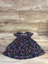 Flat lay of navy Picapino tulip-print toddler dress size 18 months showing gathered waist and flutter sleeves on light wood floor