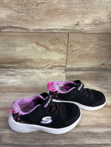 Side view of Skechers Ultra Flex black floral sneakers size 11C with pink lining, velcro strap and white sole on wood floor
