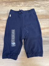 Front view of navy Ralph Lauren baby sweatpants (6M) showing elastic waistband, elastic cuffs, embroidered white Polo logo on wood background