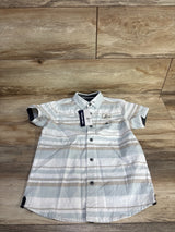 Front view of boys' striped short-sleeve button-up shirt size 5T showing pale blue, white and tan horizontal stripes and chest patch on wood floor