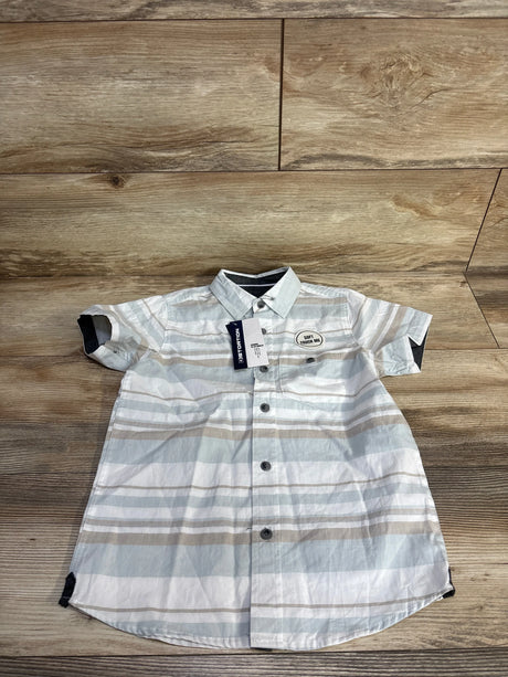 Front view of boys' striped short-sleeve button-up shirt size 5T showing pale blue, white and tan horizontal stripes and chest patch on wood floor