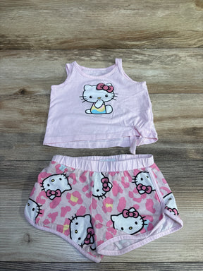 Flat lay of pink Hello Kitty tank top and shorts showing front print and elastic waistband on wood background