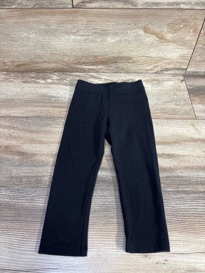 Front flat lay of Amazon Essentials toddler leggings size 2T showing elastic waistband and straight legs on light wood floor