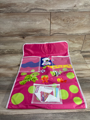 Top-down view of bath kneeling pad with organizer in pink showcasing mesh pockets, animal and polka-dot prints on wooden floor