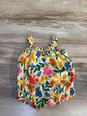 Flat lay of yellow Old Navy smocked bubble romper (3–6 months) showing ruffle-trim straps and multicolor floral print on wood background