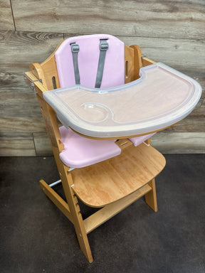 Wooden high chair with pink seat cushion and plastic tray for babies or toddlers