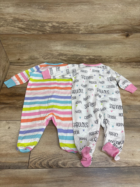 Overhead view of Gerber 2pk Sleep N’ Play sleepers, striped and white printed with pink cuffs on wood floor