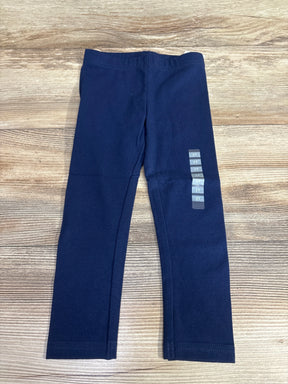 Navy blue toddler leggings size 3T on wood background, children's clothing resale