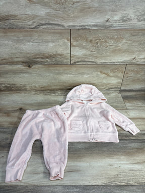 Pink baby outfit with hooded zip-up jacket and pants on wood background, kids clothing set
