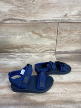 Angled view of Old Navy toddler navy double-strap sandals size 8C showing adjustable Velcro straps and textured footbed on wood floor