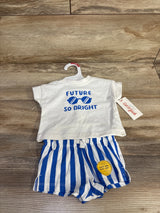 Front view of Cat & Jack newborn two-piece: white tee reading FUTURE SO BRIGHT and blue-white striped shorts on wood background