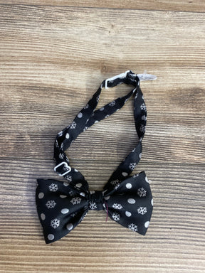 Black kids bow tie with snowflake and polka dot pattern on wood background