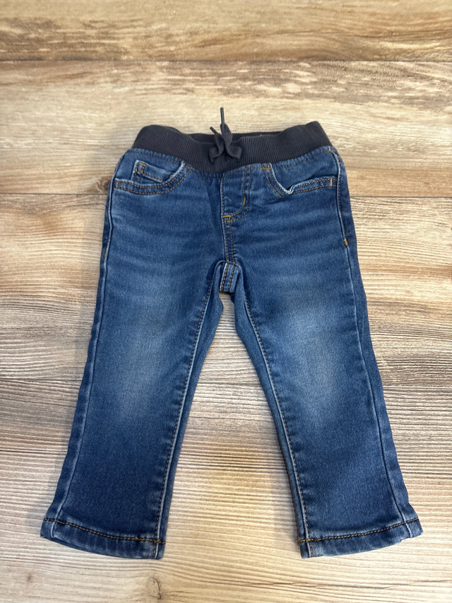 Flat lay of Wonder Nation toddler drawstring joggers, 12 months, showing elastic ribbed waistband and faded blue denim on wood