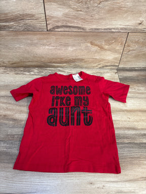 Red kids graphic t-shirt with 'awesome like my aunt' text, laid on wood floor