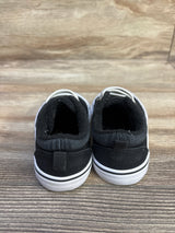 Rear view of Wonder Nation black toddler canvas sneakers showing pull tab and white rubber sole on wood surface