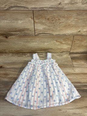 Baby girl's striped dress with blue floral print, smocked bodice, laid on wood floor