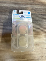 MAM silicone baby pacifiers in clear plastic case on wooden surface