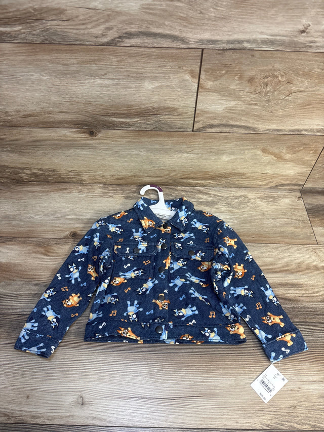 Blue toddler jacket with cartoon dog and music note print, long sleeves, laid on wood floor
