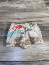 Flat lay of Carter's fish print baby shorts showcasing elastic waistband and multicolored fish pattern on light wood background