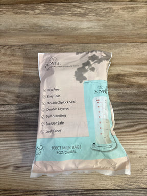 Top down view of Zomee 100 count 8 oz 240 ml breast milk storage bags showing front label features on a wooden surface
