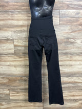 Back view of Ewedoos over-belly stretch maternity pants in black showcasing high waistband and back pockets on wood background