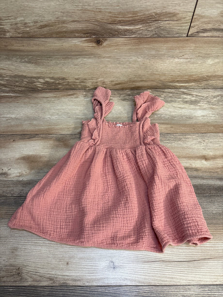 Pink ruffle sleeve baby dress on wood background, gently used kids clothing