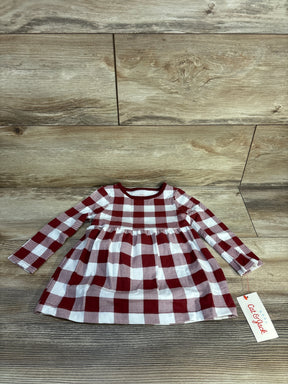 Red and white plaid long sleeve baby dress with Cat & Jack tag on wood background