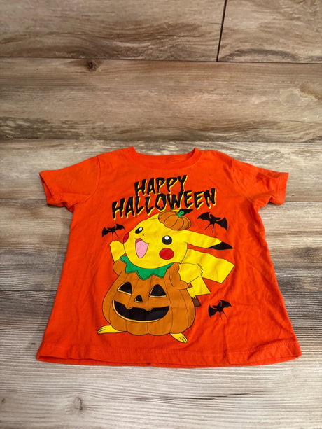 Front view of orange Pokemon Pikachu shirt, size 5/6T, with Happy Halloween text and pumpkin costume graphic on wood