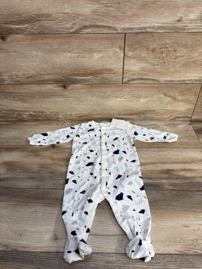 White baby onesie with blue and gray splatter pattern on wooden floor