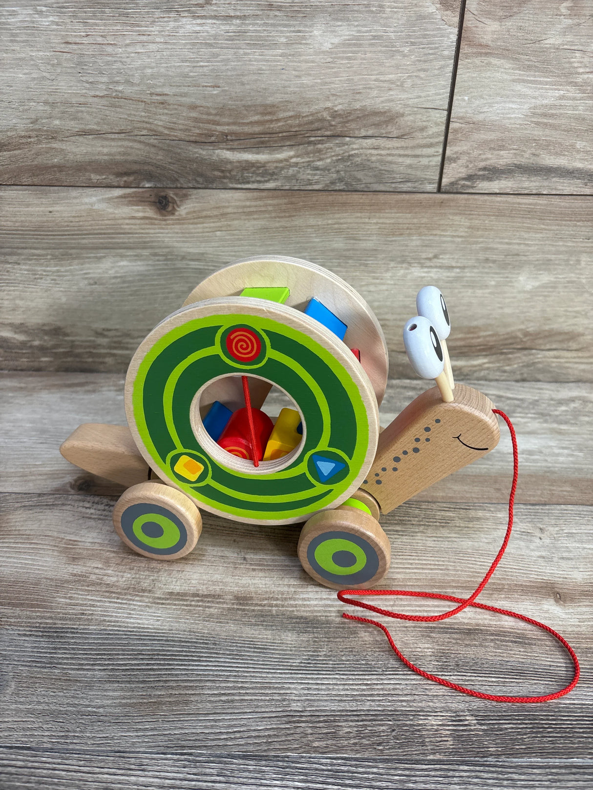 Hape Walk-A-Long Snail Shape Sorting Pull Toy