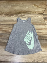 Flat lay of grey Nike tank dress showcasing large mint green Nike logo on front with wooden floor background