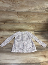 Front view of Oshkosh long sleeve floral shirt, size 4T, showcasing its white floral pattern on wood planks