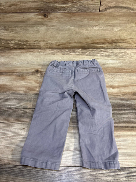 Back view of grey toddler pants, size 18-24 months, with elastic waistband and faux welt back pockets on wood