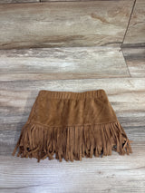 Front view of Rarity suede tassel skort in brown, size 18 months, showcasing fringe and elastic waist on a wood floor