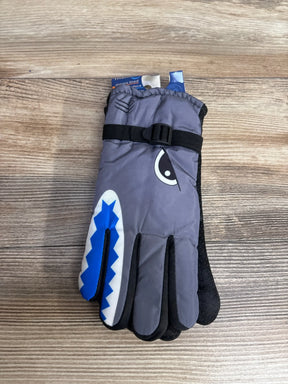 Gray children's winter glove with blue shark face and black adjustable strap on wooden surface