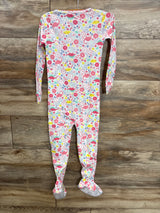 Colorful baby footed pajamas with pink dinosaurs, flowers, and blue dots on white, perfect for toddler sleepwear.
