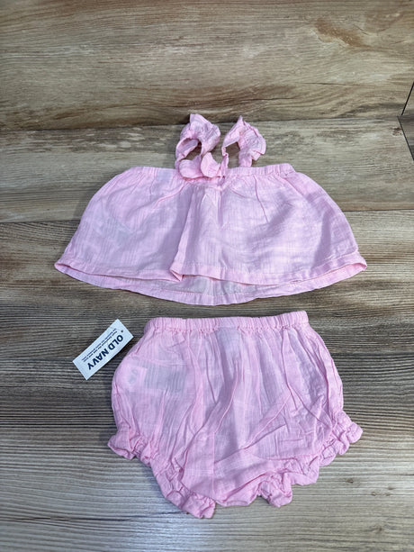 Flat lay Old Navy pink baby tank and bloomers showing ruffled shoulder ties and elastic waist on wood background