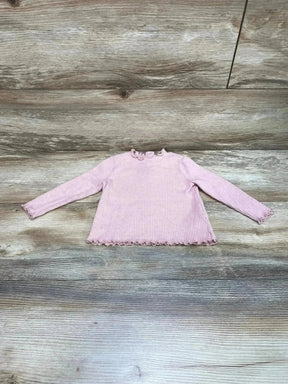 Front view of Old Navy ribbed baby shirt showcasing lettuce-trim ruffles at collar, cuffs, and hem, size 6–12 months on wood-look floor