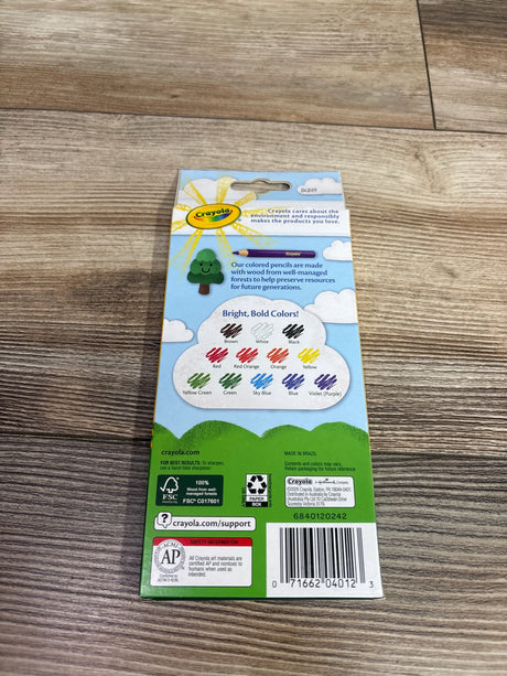Back view of NEW Crayola 12ct Colored Pencils package showcasing bright, bold color chart with wood floor background