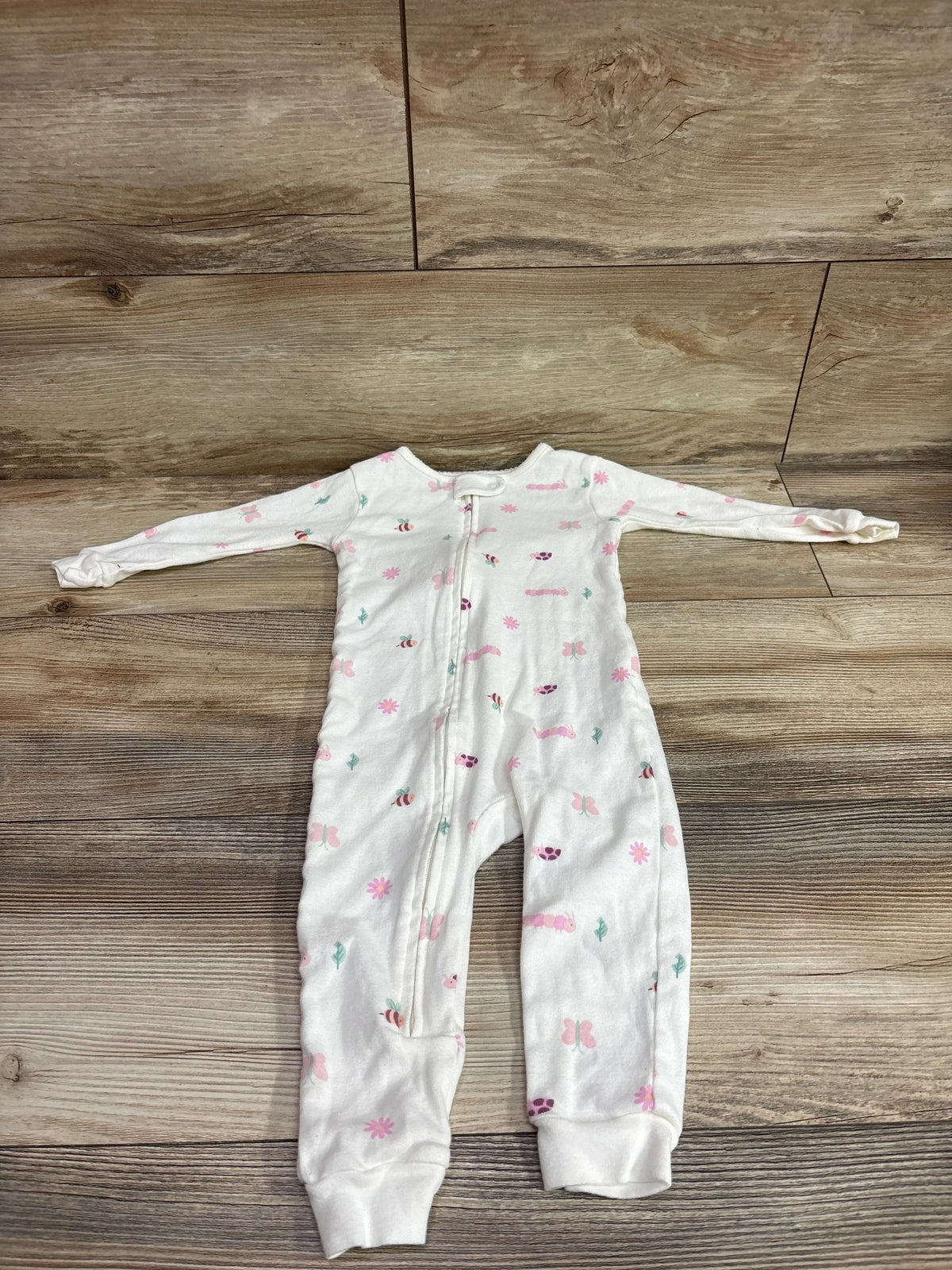Front view of Just One You white sleeper in size 18 months, showing long sleeves, front zipper, and colorful print on wood