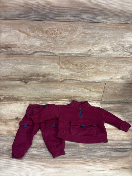 Top view of Wonder Nation 2-piece maroon sweatshirt and joggers set showcasing half-zip and front pockets on wood planks