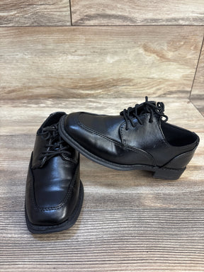 Black leather boys dress shoes with laces on wood floor, gently used kids footwear