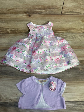 Girls’ floral sleeveless dress with lilac bolero on wood background, spring outfit