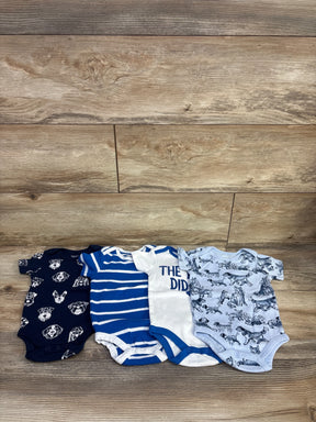 Front view of 4 pack light blue 6 month baby bodysuits showing dog print, striped, and text designs on wood background