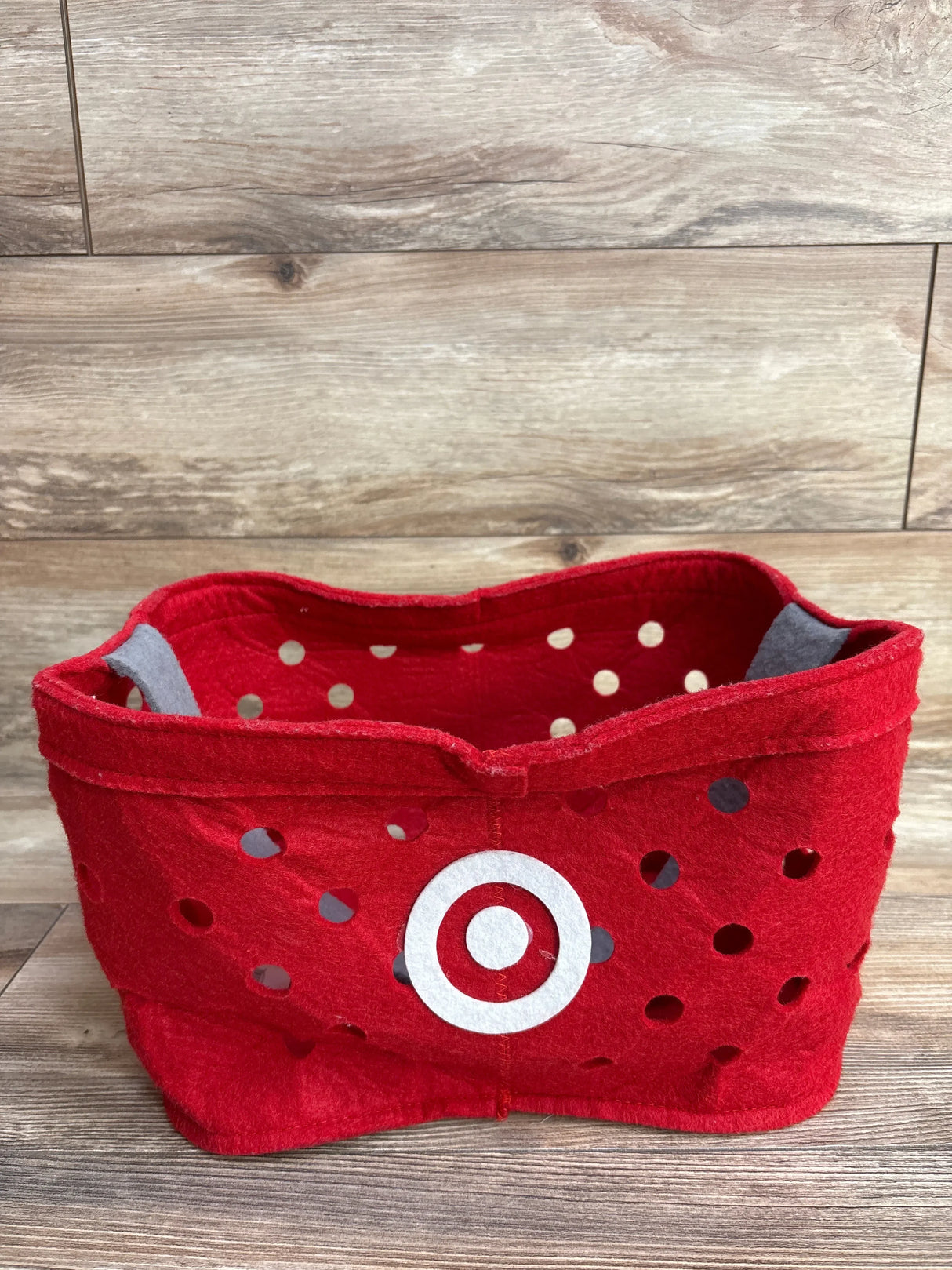 Red felt Target-themed storage basket with white bullseye logo and polka dots, ideal for kids' toys or baby gear organization.